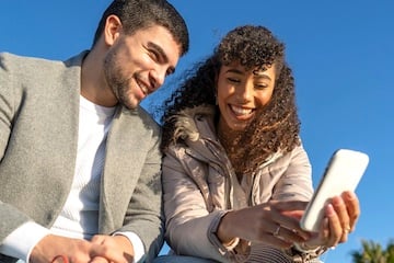 Male and female aged in the 20s looking at a smartphone