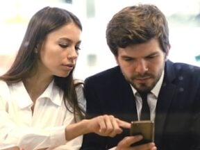 Female and male looking at a smartphone