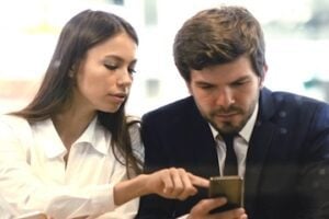 Female and male looking at a smartphone