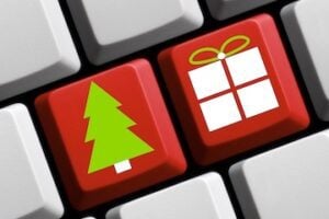 Illustration of a wrapped gift and a Christmas tree on a computer keyboard