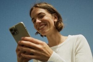Image from Attentive of a female holding a smartphone