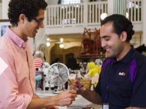 One male giving an award to another male from the FedEx home page