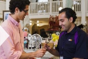 One male giving an award to another male from the FedEx home page