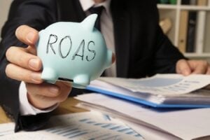 Image of a piggy-bank stamped "ROAS"