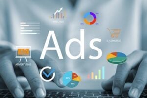 Illustration of the word "Ads" next to a laptop and digital media concepts