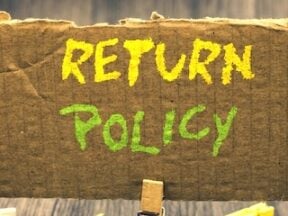 Text of "Return Policy" written on cardboard