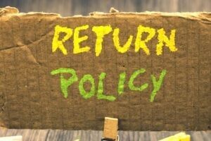Text of "Return Policy" written on cardboard