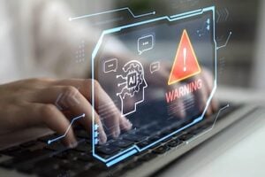 Person typing on a keyboard with an exclamation point warning superimposed