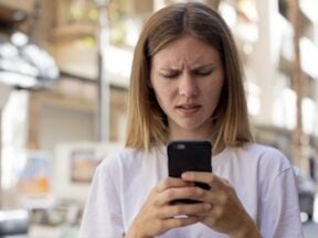 Frustrated female looking at a phone