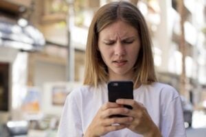 Frustrated female looking at a phone