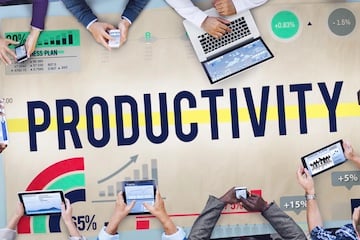 Illustration of the word "Productivity" on a conference table